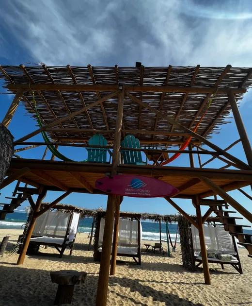 Sala en el segundo nivel con sillas y hamacas del club de playa